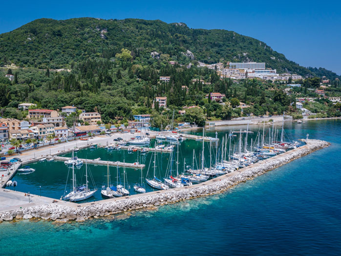 Benitses Marina, Corfu - Picturesque Harbor with Boats and Yachts Moored in Serene Waters